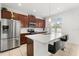 Modern kitchen with stainless steel appliances, a quartz countertop island, and stylish dark wood cabinetry at 2940 Nottel Dr, St Cloud, FL 34772