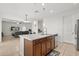 Stylish kitchen island featuring a double sink and a breakfast bar that opens into the living room at 2940 Nottel Dr, St Cloud, FL 34772
