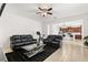 Open-concept living room with tile flooring, ceiling fan, and a view of the kitchen at 2940 Nottel Dr, St Cloud, FL 34772