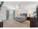 Spacious main bedroom with plush carpeting, soft lighting, and elegant decor, creating a relaxing retreat at 2940 Nottel Dr, St Cloud, FL 34772