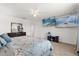 Relaxing bedroom featuring two wall-mounted tvs, a ceiling fan and dresser at 2940 Nottel Dr, St Cloud, FL 34772