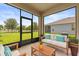 Cozy screened-in porch with comfortable seating, offering a serene outdoor space with a view of the backyard at 2940 Nottel Dr, St Cloud, FL 34772