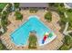 Overhead view of a resort-style swimming pool with lounge chairs and a colorful slide at 2940 Nottel Dr, St Cloud, FL 34772