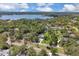 A stunning aerial view of the home on a lush lot near a beautiful lake at 303 S Sweetwater Blvd, Longwood, FL 32779