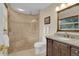 Elegant bathroom featuring a walk-in shower with built-in bench and granite countertop at 303 S Sweetwater Blvd, Longwood, FL 32779