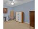 Neutral-toned bedroom featuring light-colored carpet, a window, and ample storage space at 303 S Sweetwater Blvd, Longwood, FL 32779