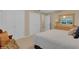 Bright bedroom with a comfortable bed, neutral decor, and ample closet space at 303 S Sweetwater Blvd, Longwood, FL 32779