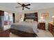 Spacious bedroom with a large bed, natural light, and access to an outdoor area at 303 S Sweetwater Blvd, Longwood, FL 32779