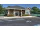 Charming clubhouse surrounded by lush landscaping and well-maintained tennis courts at 303 S Sweetwater Blvd, Longwood, FL 32779