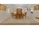Elegant dining room with classic chandelier, carpeted flooring and archway detailing at 303 S Sweetwater Blvd, Longwood, FL 32779