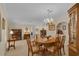Classic dining room with carpeted floors, chandelier and ample seating for entertaining at 303 S Sweetwater Blvd, Longwood, FL 32779