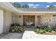 Charming entrance with stone accents, double doors, and lush landscaping at 303 S Sweetwater Blvd, Longwood, FL 32779