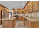 Traditional kitchen with stainless steel appliances, wood cabinetry, and a functional center island at 303 S Sweetwater Blvd, Longwood, FL 32779