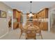Bright, open-concept kitchen featuring wooden cabinets, granite counters, and adjacent breakfast nook at 303 S Sweetwater Blvd, Longwood, FL 32779