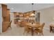 Open kitchen and dining area with wooden cabinetry, stainless steel appliances, and ample natural light at 303 S Sweetwater Blvd, Longwood, FL 32779