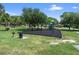 Community playground with swings, slide, and green surroundings for Gathering fun at 303 S Sweetwater Blvd, Longwood, FL 32779
