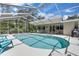 Inviting screened-in pool area with outdoor seating, perfect for relaxing or entertaining at 303 S Sweetwater Blvd, Longwood, FL 32779