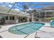 Sparkling pool in screened enclosure with lounging area and scenic backyard view at 303 S Sweetwater Blvd, Longwood, FL 32779