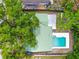 Aerial view of property with the pool, patio and a large tree providing shade at 3054 Bluebrook Dr, Winter Park, FL 32792