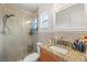 Modern bathroom featuring tiled walls and flooring, a large shower, and a granite vanity at 3054 Bluebrook Dr, Winter Park, FL 32792