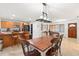 Dining room with a wooden table and chairs plus an adjacent kitchen with an island at 3054 Bluebrook Dr, Winter Park, FL 32792