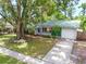 This single-story home has a metal roof, mature landscaping, and a one car garage at 3054 Bluebrook Dr, Winter Park, FL 32792