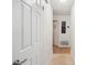 Bright hallway features neutral paint, tile and wood flooring, and white doors at 3054 Bluebrook Dr, Winter Park, FL 32792