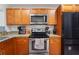 Efficient kitchen featuring stainless steel appliances, granite countertops, and ample cabinet space at 3054 Bluebrook Dr, Winter Park, FL 32792