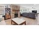 Open living room with hardwood floors, a brick fireplace, and modern furniture at 3054 Bluebrook Dr, Winter Park, FL 32792