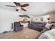 Bright living room featuring a stacked wood wall, hardwood floors, and comfortable seating at 3054 Bluebrook Dr, Winter Park, FL 32792