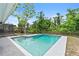 Beautiful in-ground swimming pool surrounded by lush landscaping and complemented by an outdoor pergola at 3054 Bluebrook Dr, Winter Park, FL 32792