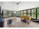 View of a screened-in porch featuring a dining area and recreational space with ample natural light at 3054 Bluebrook Dr, Winter Park, FL 32792