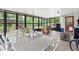 Spacious screened porch featuring a dining area and recreational space with ample natural light at 3054 Bluebrook Dr, Winter Park, FL 32792