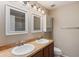 Bathroom featuring double sinks, vanity and modern lighting, providing a bright and functional space at 3112 Seaview Castle Dr, Kissimmee, FL 34746