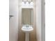 Cozy half-bathroom featuring a pedestal sink, mirror, and neutral paint, creating a clean and simple design at 3112 Seaview Castle Dr, Kissimmee, FL 34746
