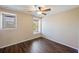 This bedroom has wood laminate flooring, a ceiling fan, and natural light from two windows at 3112 Seaview Castle Dr, Kissimmee, FL 34746