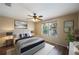 Tastefully furnished bedroom with hardwood floors, a ceiling fan, and window view, exuding cozy comfort at 3112 Seaview Castle Dr, Kissimmee, FL 34746
