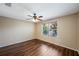 Bedroom with hardwood floors, a ceiling fan, and a window offering natural light and a view of lush greenery at 3112 Seaview Castle Dr, Kissimmee, FL 34746
