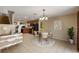 Open-concept dining area with modern decor, adjacent to the kitchen featuring wood cabinets at 3112 Seaview Castle Dr, Kissimmee, FL 34746
