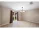 Dining area with tile floors, modern chandelier, and sliding glass doors overlooking the backyard at 3112 Seaview Castle Dr, Kissimmee, FL 34746