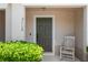Close-up of front porch, showing a lovely chair and well-kept landscaping at 3112 Seaview Castle Dr, Kissimmee, FL 34746