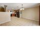 Kitchen with wooden cabinets, black appliances, and tiled floor adjoining a spacious dining area at 3112 Seaview Castle Dr, Kissimmee, FL 34746