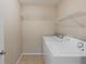 A utility room with a washer and dryer hookup with installed appliances and wire shelving at 3112 Seaview Castle Dr, Kissimmee, FL 34746