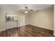 Open living area with wood-look floors and a view into the adjacent kitchen at 3112 Seaview Castle Dr, Kissimmee, FL 34746