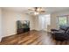 Inviting living room with wood flooring, a ceiling fan, and neutral wall color at 3112 Seaview Castle Dr, Kissimmee, FL 34746