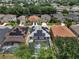 Aerial view of a neighborhood featuring solar panels on house roofs at 325 Aldridge Ln, Davenport, FL 33897