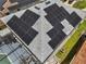 Aerial view of roof with solar panels, backyard pool, and sunroom at 325 Aldridge Ln, Davenport, FL 33897