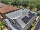 Aerial view of a gray-shingled house roof equipped with solar panels at 325 Aldridge Ln, Davenport, FL 33897