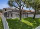 A spacious backyard features a well-maintained lawn, mature trees, and a screened-in pool enclosure for outdoor enjoyment at 325 Aldridge Ln, Davenport, FL 33897
