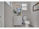 Cozy bathroom with white vanity, framed mirror, and toilet, offering a clean, functional space at 325 Aldridge Ln, Davenport, FL 33897